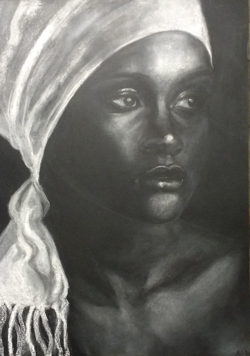 Portrait of an African woman wearing white headscarf.