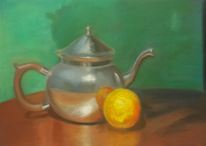 Silver teapot and an orange on a light brown coffee table with green background.