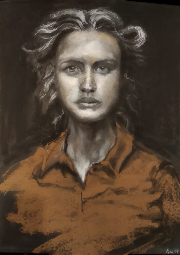 Portrait of a blond women wearing dark orange shirt on a dark gray background.