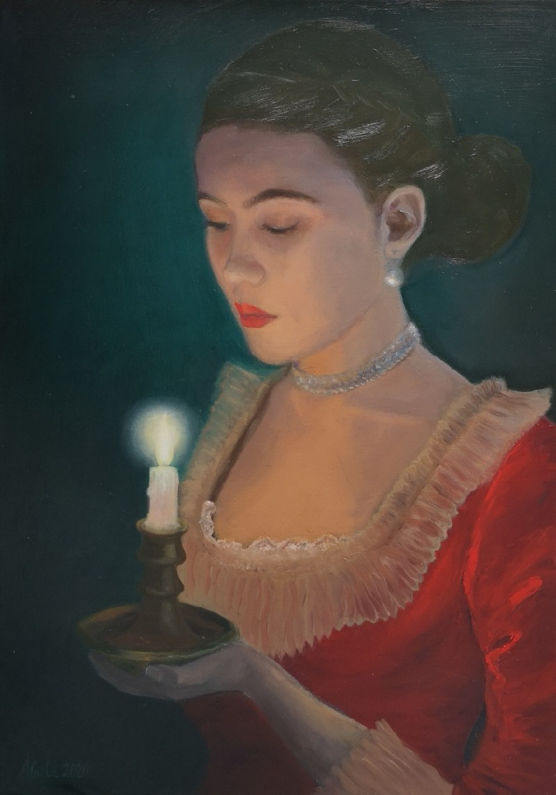 A woman in a red dress is holding a burning candle.